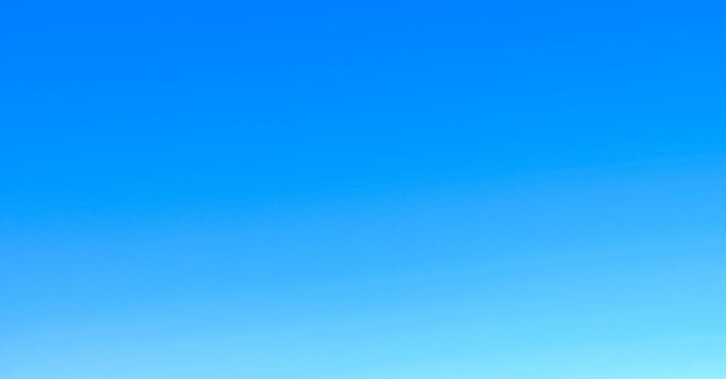 A serene view of a vibrant clear blue sky with a subtle gradient, perfect for backgrounds.